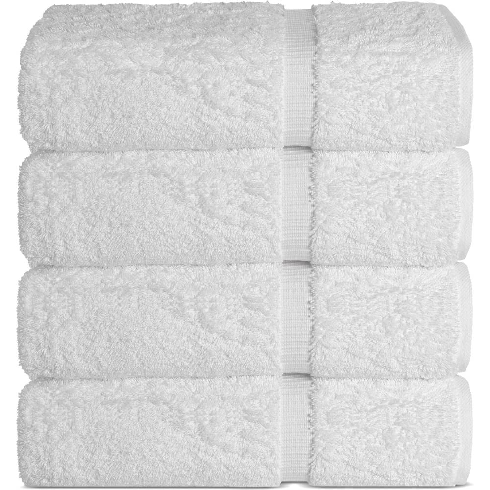A stack of four white Turkish cotton bath towels